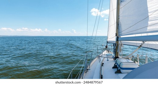 Luxury cruise on a sailing rigged yacht under a genoa and mainsail sailing in a light wind during the regatta. Yachting, sport, vacation. View from the deck to the bow, mast, sails. Banner - Powered by Shutterstock