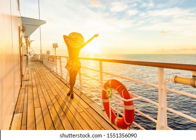 Luxury cruise ship travel elegant woman having fun carefree on deck enjoying watching sunset on Europe cruising destination vacation. Summer european mediterranean cruiseship sailing away on holiday.