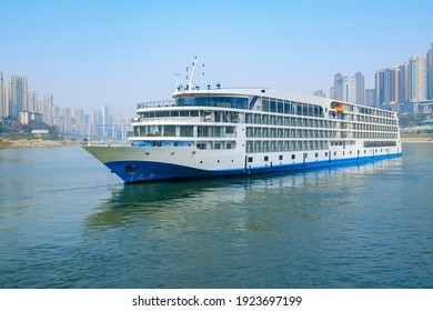 Luxury Cruise Ships Sailing On The Yangtze River, The City Skyline In Chongqing, China