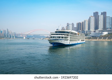 Luxury Cruise Ships Sailing On The Yangtze River, The City Skyline In Chongqing, China