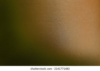 luxury dark brown leather texture background showing grain and a shaft of light across. gradient brown artificial leatherette texture use as background, close up view, with blank space for design.