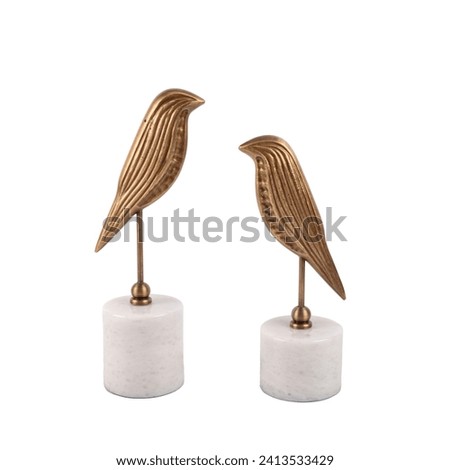 luxury decorative metal bird figures on marble isolated on white background