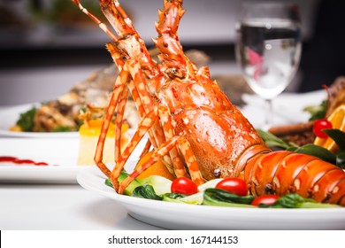 A Luxury Dish Of Lobster Roasted And Decorated With Many Items Of Vegetable