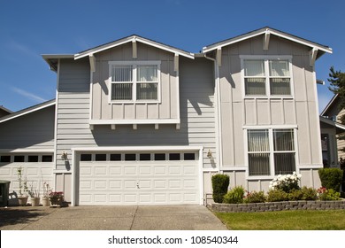 Luxury Family House With Landscaping On The Front And Blue Sky On Background