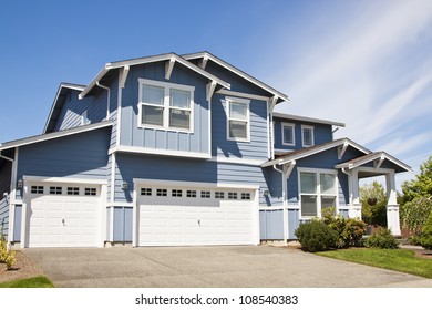 Luxury Family House With Landscaping On The Front And Blue Sky On Background