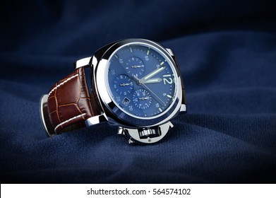 luxury fashion watch with blue dial and brown crocodile grain leather watch band - Shutterstock ID 564574102