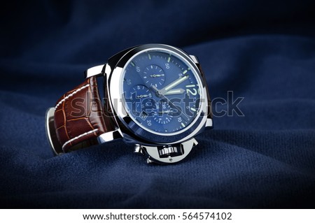 luxury fashion watch with blue dial and brown crocodile grain leather watch band