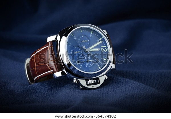 luxury fashion watch with blue dial and brown\
crocodile grain leather watch\
band
