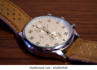 Luxury fashion watch with and brown leather watch band.