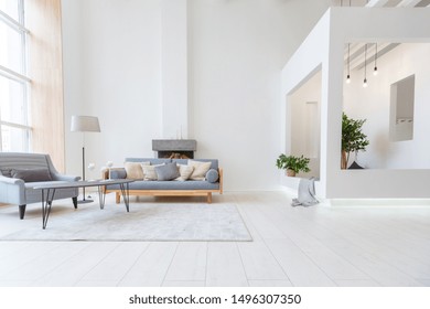 Luxury fashionable modern design studio apartment with a free layout in a minimal style. very bright huge spacious room with white walls and wooden elements. sitting area with fireplace - Powered by Shutterstock