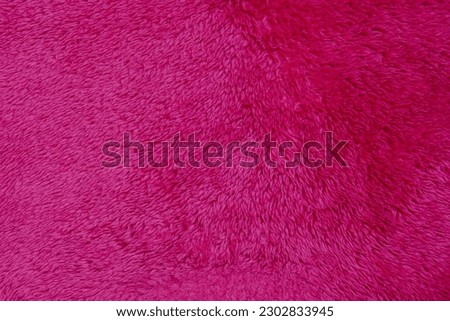 Luxury fashionable of pink fur coat texture for background It's soft winter fashion hanging. 