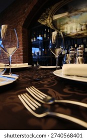 Luxury fine dining table setting with wine glasses and elegant restaurant interior