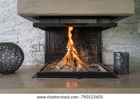 Luxury Fireplace. Fireplace in a modern luxury home with burning fire.