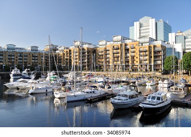 Luxury flats, City Quay, and yachts moored in the east dock marina, St Katherine Dock, London, England, UK, Europe