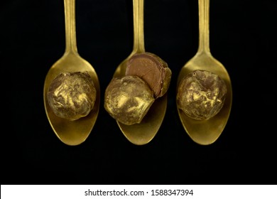 Luxury Golden Bonbons On Black Background.