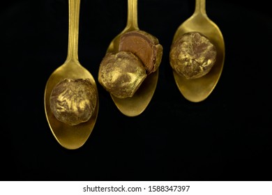 Luxury Golden Bonbons On Black Background.