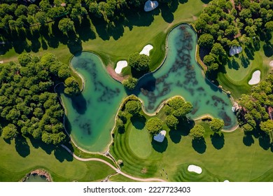 Luxury Green golf course field with lake Antalya Belek Turkey, aerial top view. - Shutterstock ID 2227723403