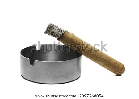 Luxury handmade cigar glowing ember in metal ashtray isolated on white