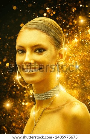 Luxury holiday style. Christmas beauty girl. Gorgeous young woman with golden make-up and skin on a dark background with sparkling golden lights.