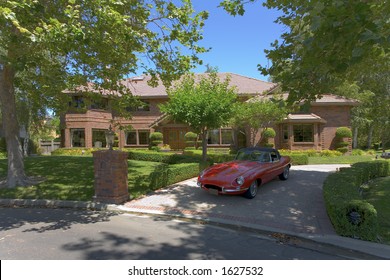 Luxury Home with a 60s Jag in front