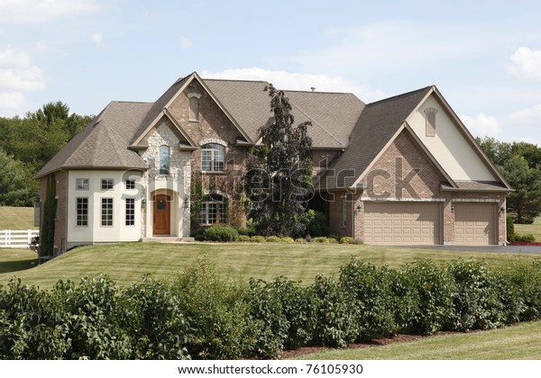 Luxury home\
with arched entry and three car\
garage