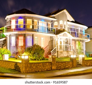 Luxury Home Exterior In The Night Time Illuminated With Lights