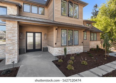 Luxury Home Exterior On Sunny Day With Blue Sky. Detail Of Entryway