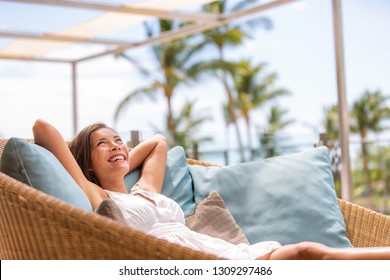 Luxury Hotel Home Living Woman Relax Enjoying Sofa Furniture Of Outdoor Patio. Beautiful Young Multiracial Asian Girl Relaxing Day Dreaming For Rich Early Retirement In Getaway Tropical House.