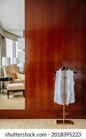 Luxury Hotel Room Suit Valet Stand With White Shirt Hanging Next To Fitting Mirror Vertical Length.