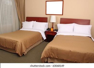 A Luxury Hotel Room With Two Queen Beds