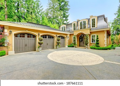 Luxury House With Beautiful Curb Appeal. View Of Three Car Garage And Driveway