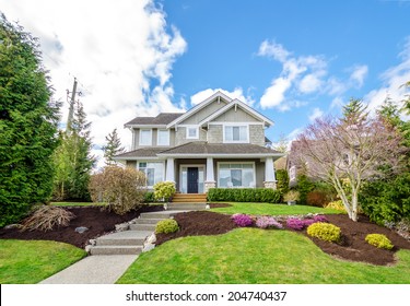 Luxury House With Beautiful Landscaping On A Sunny Day. Home Exterior Design.