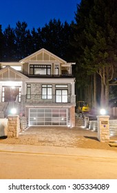 A Luxury House With Driveway  In Suburbs At Dusk, Night, Dawn Time In Vancouver, Canada.