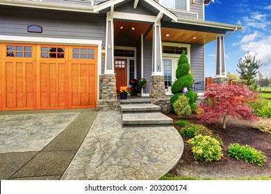 Luxury House Entrance Porch With Stone Column Trim. View Of  Walkway With Landscape