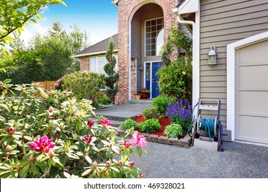 Luxury House Exterior With Brick And Siding Trim, Concrete Floor Porch. Well Kept Garden Around. Northwest, USA