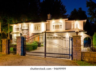 A luxury house with the gates in suburbs at dusk in Vancouver, Canada