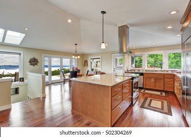 Luxury House Interior With Open Floor Plan, Dining Area And Modern Kitchen Room With Vaulted Ceiling . Northwest, USA