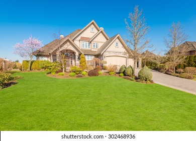 Luxury House With Perfect Green Lawn In Front Yard In Vancouver, Canada.