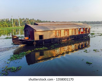 A Luxury Houseboat Floats Serenely On The Backwaters Of Allepey,Kerala In India During The Daytime As Part Of A Tourist Attraction