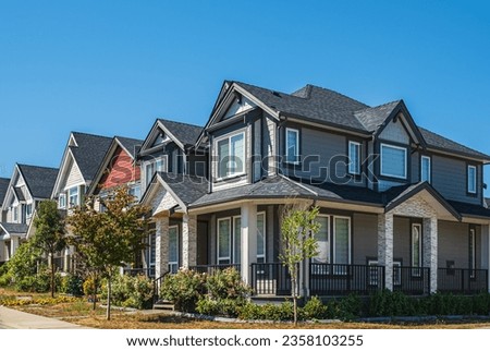Luxury houses exterior in Vancouver Canada. Big modern houses with beautiful landscaping. Perfect neighborhood. Front view of modern designed residential houses. North American Homes in the suburbs