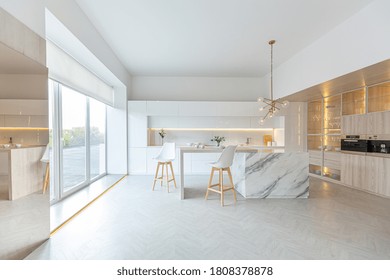 luxury interior design of modern trendy snow white kitchen in minimalistic style with island and two bar stools. huge windows to the floor and a glass rack for dishes