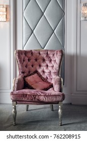 Luxury Interior. Luxurious Pink Velvet Armchair, Antique Carved Furniture, Classic Interior Detail