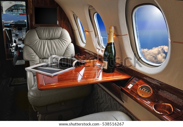 luxury interior in the\
modern  business jet and sunlight at the window/sky and clouds\
through the porthole