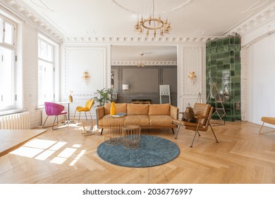 luxury interior of a spacious apartment in an old 19th century historical house with modern furniture. high ceiling and walls are decorated with stucco - Powered by Shutterstock