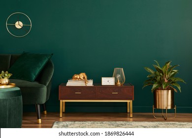 Luxury Interior With Stylish Velvet Sofa, Wooden Commode, Pouf, Plants, Carpet, Gold Decoration, Copy Space And Elegant Personal Accessories. Modern Living Room In Classic House. Template.