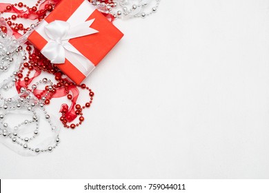 Luxury Jewelry Present For Women On White Background. Red Ribbon Wrapped Gift Box. Expensive Surprise On Women Day, Mothers Day, Valentines Day, New Year, Christmas, Thanksgiving And Other Holidays.