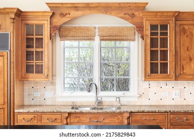 A Luxury Kitchen Detail Shot With Wood Cabinets And Granite Countertops.