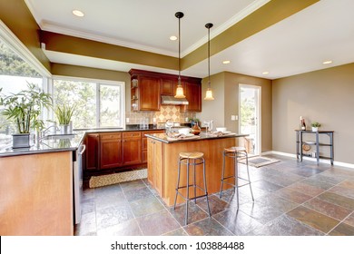 Luxury Kitchen Interior With Green Walls And Stone Floor And Bright Windows.