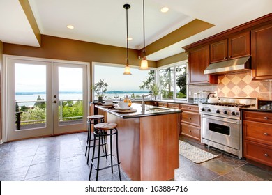 Luxury Kitchen Interior With Green Walls And Stone Floor And Water View.