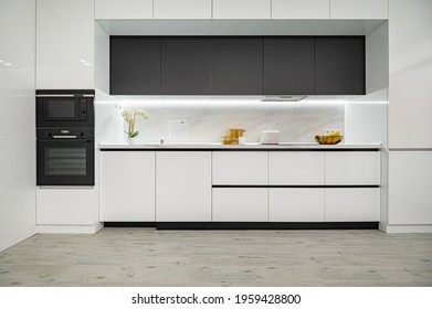 Luxury large modern white and black kitchen interior used as showcase, front view - Powered by Shutterstock